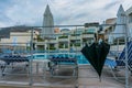 Bali, Crete, Greece - 08.10.2019: after the rain by the pool in the resort. Folded beach umbrellas and a large black umbrella Royalty Free Stock Photo