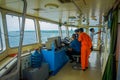 BALI, INDONESIA - APRIL 05, 2017: Ferry boat pilot command cabin with the captain operating the machines with a many