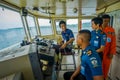 BALI, INDONESIA - APRIL 05, 2017: Ferry boat pilot command cabin with view on the sea with many assistants there in Ubud
