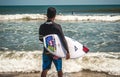 Male surfer on a beach preparing to catch some waves Royalty Free Stock Photo