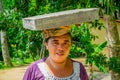 BALI, INDONESIA - APRIL 05, 2017: Women walk in the rice fields with basket on her head in Ubud, Bali, Indonesia