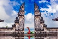 BALI,INDONESIA-AUGUST 19,2019:Asian female tourist poses for a photo shoot at Lempuyang Luhur temple in Bali, Indonesia