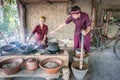 Old woman and young man roasting luwak coffee beans in Ubud
