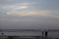 Bali, Indonesia - CIRCA 2018: Group of fisherman fishing for fish in ocean water during sun set with a beautiful colored cloudy