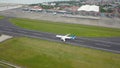 Bali, Indonesia, December 4, 2020. Aerial view passengers airplanes at the airport runway. Garuda Indonesia plane taking off from