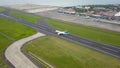 Bali, Indonesia, December 4, 2020. Aerial view passengers airplanes at the airport runway. Garuda Indonesia plane taking off from