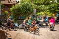 balinese road traffic, scooter drivers wait on crossroads. Royalty Free Stock Photo