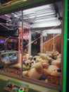 Bali, Indonesia - December 19, 2020: A green dools Claw game machine in the Timezone Play Area located at Bali Galleria Mall