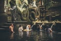 BALI, INDONESIA - DECEMBER 5, 2017: Holy spring water. People praying in the Tirta Empul temple. Bali, Indonesia. Royalty Free Stock Photo