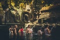 BALI, INDONESIA - DECEMBER 5, 2017: Holy spring water. People praying in the Tirta Empul temple. Bali, Indonesia. Royalty Free Stock Photo