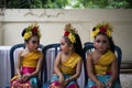 BALI/INDONESIA-DECEMBER 28 2017:Three young Balinese dancers wearing traditional Balinese clothes and make up, were preparing to Royalty Free Stock Photo