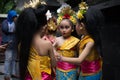 BALI/INDONESIA-DECEMBER 28 2017:Three young Balinese dancers wearing traditional Balinese clothes and make up, were preparing to Royalty Free Stock Photo