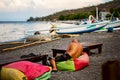 Tourist relaxing in typical small Black Sand Beach cafe on Bali Royalty Free Stock Photo