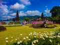 Bali, Indonesia. A group of people of all ages and backgrounds stand together in front of Ulundanu temple, smiling and Royalty Free Stock Photo