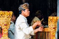 Bali - Indonesia - 10.22.2015: Indonesian man dressed in traditional clothes playing the balinese gamelan with a straight face