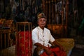 Bali - Indonesia - 10.22.2015: Indonesian musician dressed in traditional clothes sitting alone with a straight face