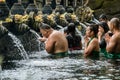 People praying in the holy spring water of Pura Tirta Empul  temple in Tampa, Bali, Indonesia Royalty Free Stock Photo