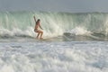 Bali, Indonesia - January 18, 2023: Surf in Keramas beach, Bali, Indonesia, Woman surfing waves with a surf board