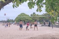 BALI, INDONESIA - JULY 27, 2017: Group of friends playing beach volley - Multi-ethic group of people having fun on the