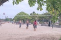 BALI, INDONESIA - JULY 27, 2017: Group of friends playing beach volley - Multi-ethic group of people having fun on the