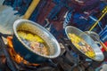 BALI, INDONESIA - MARCH 08, 2017: Cooking on a frying pan a dough for chapati on Manmandir in a blurred background