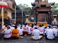 Illustrative Editorial showing traditional Balinese male and female in ceremonial clothing at the