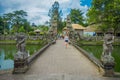 BALI, INDONESIA - MARCH 08, 2017: Unidentified woman walking inside of the temple of Mengwi Empire located in Mengwi