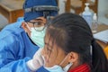 BALI/INDONESIA-MAY 28 2021: An ENT doctor is examining the ears, nose and throat of a pediatric patient. During the COVID-19