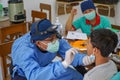 BALI/INDONESIA-MAY 28 2021: An ENT doctor is examining the ears, nose and throat of a pediatric patient. During the COVID-19