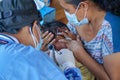 BALI/INDONESIA-MAY 28 2021: An ENT doctor is examining the ears, nose and throat of a pediatric patient. During the COVID-19