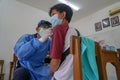 BALI/INDONESIA-MAY 28 2021: An ENT doctor is examining the ears, nose and throat of a pediatric patient. During the COVID-19