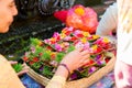 Bali, Indonesia, May 3, 2015. Female hands offering food to God, traditional Balinese offerings to gods in Bali with flowers and Royalty Free Stock Photo