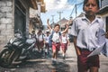 BALI, INDONESIA - MAY 23, 2018: Group of balinese schoolboys in a school uniform on the street in the village.