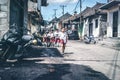 BALI, INDONESIA - MAY 23, 2018: Group of balinese schoolboys in a school uniform on the street in the village.