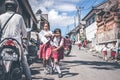 BALI, INDONESIA - MAY 23, 2018: Group of balinese schoolboys in a school uniform on the street in the village.