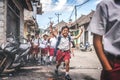 BALI, INDONESIA - MAY 23, 2018: Group of balinese schoolboys in a school uniform on the street in the village. Royalty Free Stock Photo