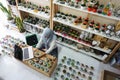 BALI/INDONESIA-MAY 25 2019: A Muslim businesswoman is selling succulent plants on internet. She has a clean and white workshop.