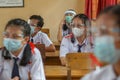 BALI,INDONESIA-MAY 18 2021: Students in Indonesia are following the learning process in class using faceshields and health masks