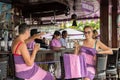 BALI, INDONESIA - MAY 5, 2017: Two women drinking coffe and relaxing in swimming pool bar and restaraunt. Bali. Royalty Free Stock Photo