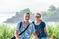 BALI, INDONESIA - MAY 4, 2017: Woman and her son on a background of Pura Tanah lot temple, Bali island, Indonesia. Royalty Free Stock Photo