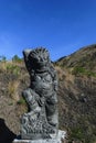 Bali, Indonesia. 5 OCT 2018. Scary looking traditional Bali island stone sculpture in front of the blue sky background