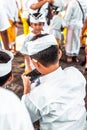 BALI, INDONESIA - OCTOBER 9, 2018: Balinese boys with smartphone on a traditional ceremony in Ubud.