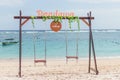 BALI, INDONESIA - OCTOBER 8, 2017: Lonely swing on the beach at Pandawa beach, Bali island, Indonesia. Royalty Free Stock Photo