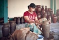 Rural asian potter master woman molds from clay pot