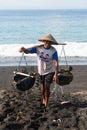 Traditional sea salt production on the volcanic black sand, Bali