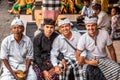 BALI, INDONESIA - SEPTEMBER 25, 2018: Balinese men with european man in traditional clothes on a big ceremony in Tirta