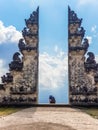 Tourists take photos at the gates of Pura Lempuyang Luhur Temple in Bali, Indonesia