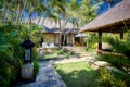 Balinese pavilion style architecture around a pool and garden