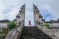 Bali, Indonesia. Young taveler man jumping with energy and happiness in the gate of heaven. Lempuyang temple
