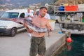 Bali, Island Crete, Greece, - June 30, 2016: Man is a fisherman carries a big fish sawfish